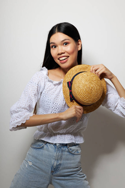 Portrait Asian beautiful young woman hat in hand posing smile isolated background unaltered - Fotó, kép
