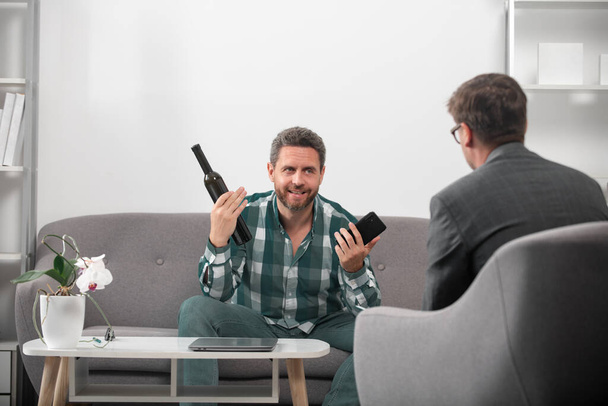 Solving problem, alcohol addiction, man alcohol abuse. Psychology, mental therapy concept. Man and psychologist at psychotherapy session. - Photo, Image