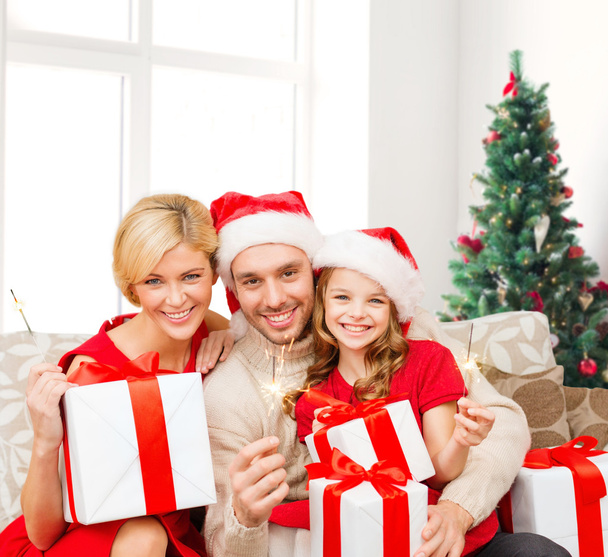 happy family in santa helper hats with gift boxes - Фото, изображение
