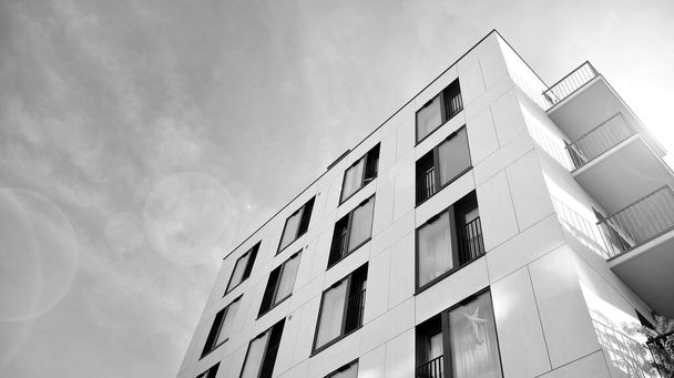 Modern luxury residential flat. Modern apartment building on a sunny day. White apartment building with a blue sky. Facade of a modern apartment building. Black and white. - Foto, Imagen