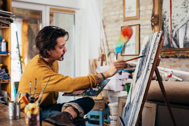 man making a paint in his atelier - Fotó, kép