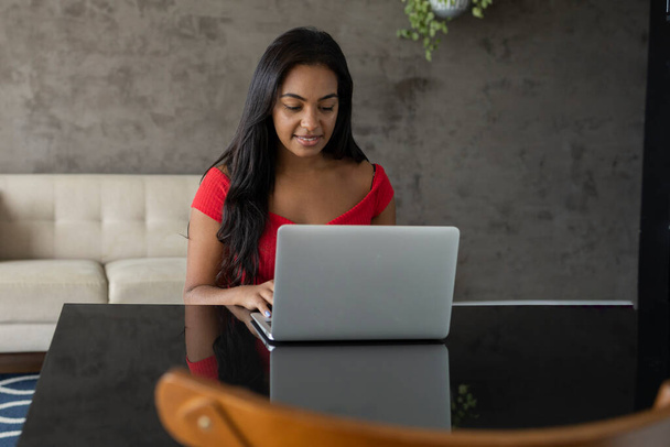 Young black woman working at home with laptop on desk.  Home office concept. Gray notebook for working. High quality photo - Fotoğraf, Görsel