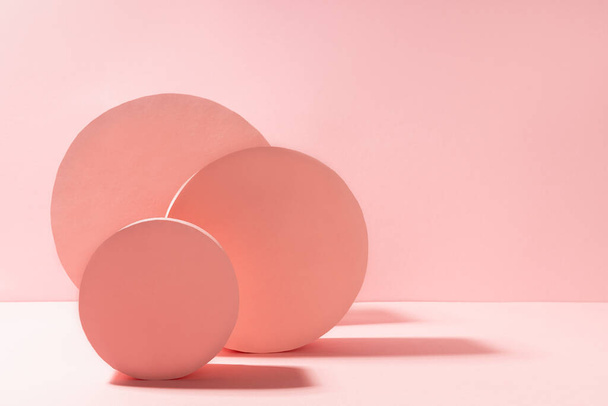 Modern geometric abstract stage mockup with pastel pink round shapes in sunlight with shadows on soft light background, copy space. Abstract scene  for presentation products, advertising, design. - Фото, зображення