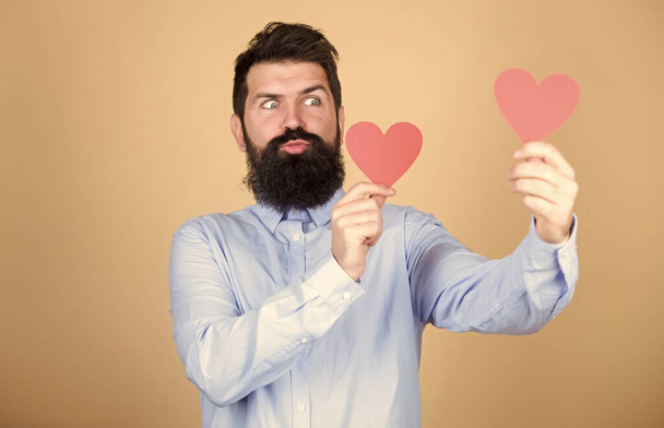 Every day is valentines day. Sexy valentine man with heart shaped cards. Happy valentines day. Romantic love celebration. Bearded man holding red hearts. Hipster with small hearts - Foto, Imagem