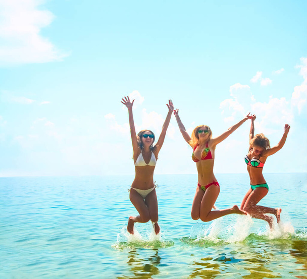 group of happy young women having fun in   water  - 写真・画像