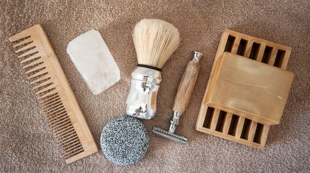 Zero waste bathroom accessories for men. Wooden comb, potassium alum salt deodorant, aleppo soap and solid shampoo, bamboo and steel safety razor, shaving soap and brush. Eco friendly, plastic free. - Photo, Image
