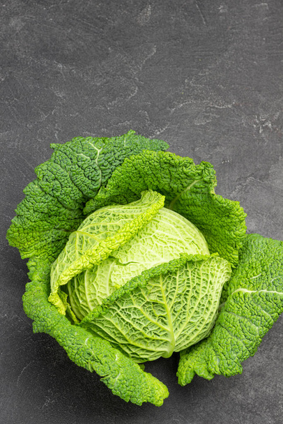 Savoy cabbage on black background. Copy space. Flat lay.  - Photo, image