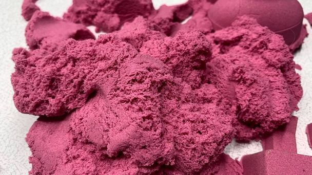 Pink kinetic sand for children, development and play at home with multi-colored sandbox molds - Φωτογραφία, εικόνα