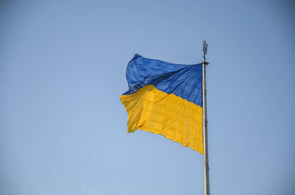 National Ukrainian flag waving in the wind on the background of the blue sky - Foto, Bild