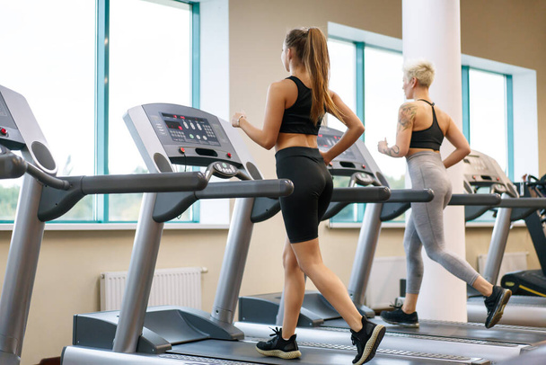 A young woman is doing fitness with a trainer at the GYM - Valokuva, kuva