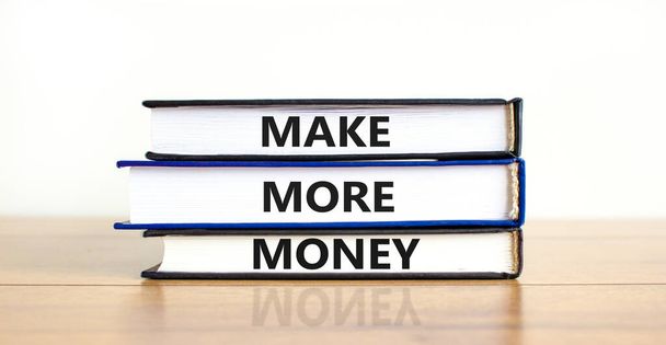 Make more money symbol. Concept words Make more money on books on beautiful wooden table white background. Business, make more money concept. Copy space. - Fotó, kép
