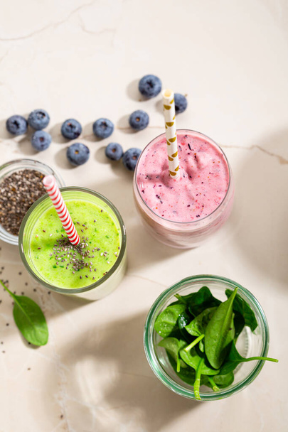 Green and pink smoothie with chia seeds and berry - Photo, Image