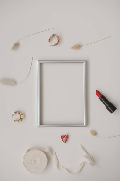 minimal fashion mockup with empty photo frame and red lipstick and womens accessories on white background - Fotoğraf, Görsel