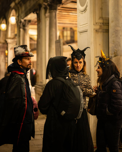 Venice, Italy - October 31, 2021: People dressed for halloween in San Marco at night - Zdjęcie, obraz