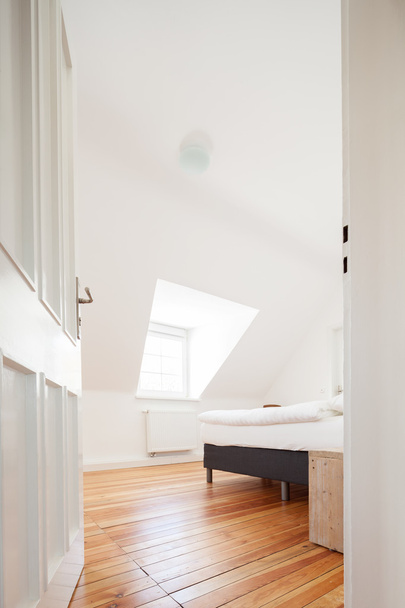 Loft bedroom with sloping ceiling - Fotoğraf, Görsel