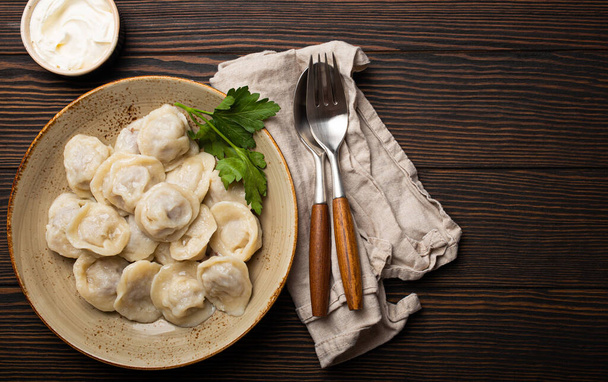 Pelmeni, traditional dish of Russian cuisine, boiled dumplings with minced meat - Photo, Image