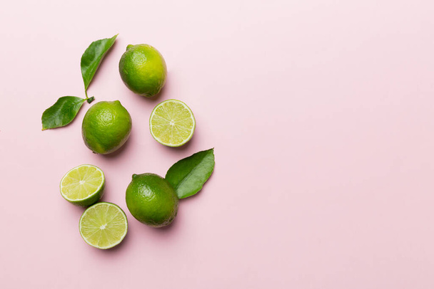 Lime fruits with green leaf and cut in half slice isolated on white background. Top view. Flat lay with copy space. - Foto, immagini