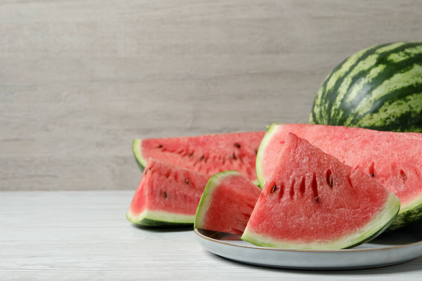 Tasty ripe watermelons on white wooden table, space for text - Foto, immagini