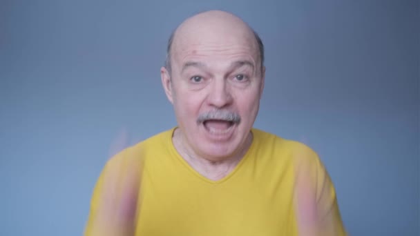 Bald senior man being shocked with surprise expression and excited face. - Footage, Video