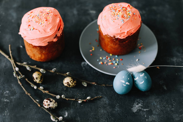 Easter cakes with decorations, colorful eggs and willow branches. Happy Easter holiday concept. - Fotó, kép