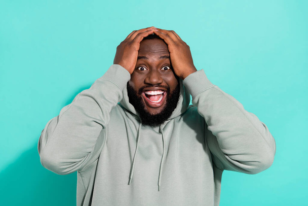 Portrait of attractive cheerful overwhelmed guy news reaction win lottery isolated over bright teal turquoise color background - Фото, изображение