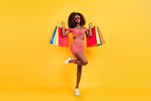 Full size of stunning feminine wear sunglass sexy summer costume go shopping on black friday isolated on yellow color background - Photo, Image