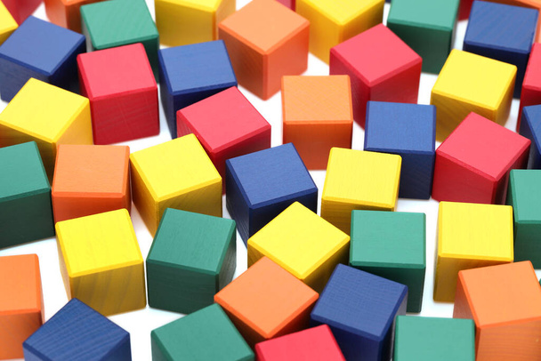 small wooden colorful building blocks scattered on a white background  - Photo, Image