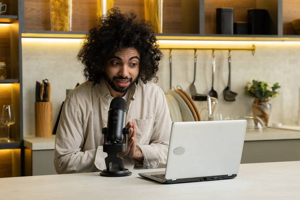 Egyptian man voicing broadcast via laptop and microphone - Zdjęcie, obraz