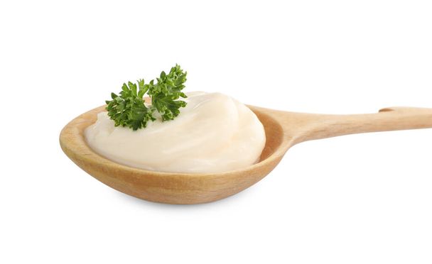 Wooden spoon with tasty mayonnaise and parsley isolated on white - Fotografie, Obrázek