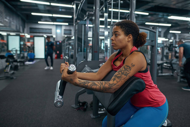 Black girl doing sport exercise for biceps muscles - 写真・画像