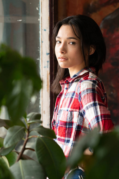 young beautiful woman pose in red plaid shirt in studio - Photo, image