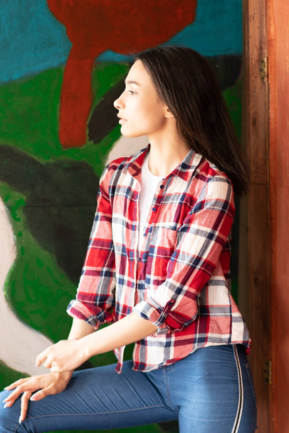 young beautiful woman pose in red plaid shirt in studio - Foto, afbeelding