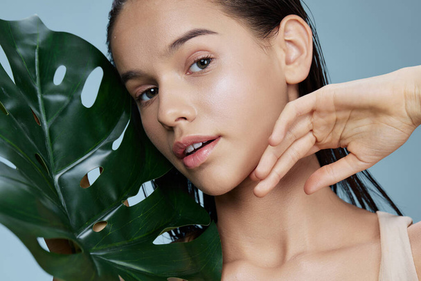 woman palm leaf in the tropics skin care cosmetology close-up Lifestyle - Φωτογραφία, εικόνα