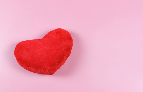 Top view or flat lay of red heart pillow on pink background with copy space, isolated. Valentine's day concept. - Foto, imagen