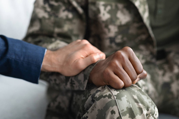 Cropped of psychologist comforting military man during session - Photo, Image