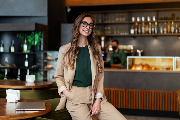 Business Woman Restaurant Owner Dressed Elegant Pantsuit Standing In Restaurant With Bar Counter Background Caucasian Female Glasses Business Person Indoor hands in pockets - 写真・画像