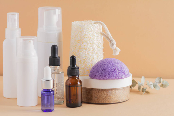 Beauty, spa and wellness concept. Facial cosmetic products, konjac sponge on a beige background. Health and medicine concept, beauty and selfcare. Front view - Fotó, kép