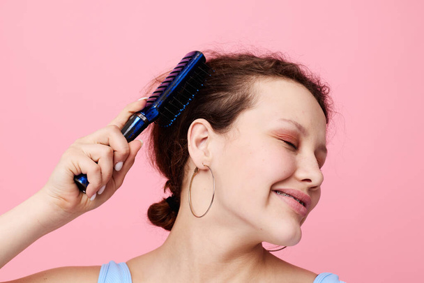 teenager girl removes hair on a comb dissatisfaction close-up unaltered - Photo, Image