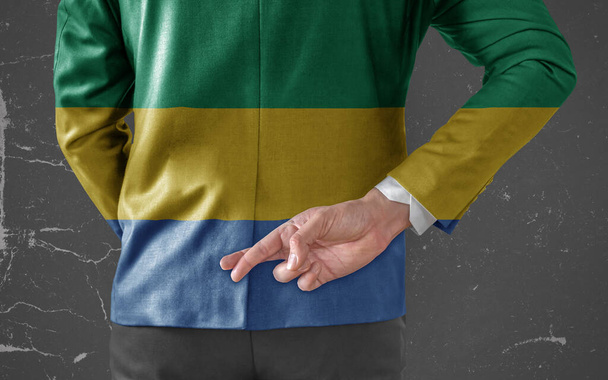 Businessman Jacket with Flag of Gabon with his fingers crossed behind his back  - Fotografie, Obrázek