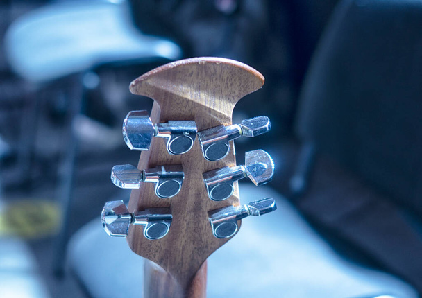 Electric guitars before the concert stand on stage under the light of spotlights. - Photo, Image