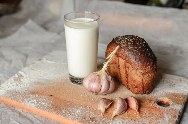 Still life of milk, bread and garlic. - Fotografie, Obrázek