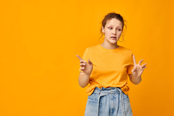 funny girl in a yellow t-shirt posing emotions isolated backgrounds unaltered - Fotó, kép
