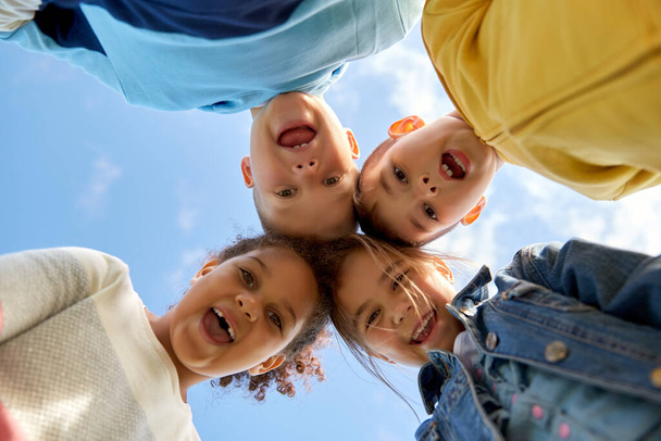 multiethnic group of happy children under blue sky - Photo, Image