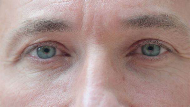 Close up of One Blinking Eye of Man - Photo, Image