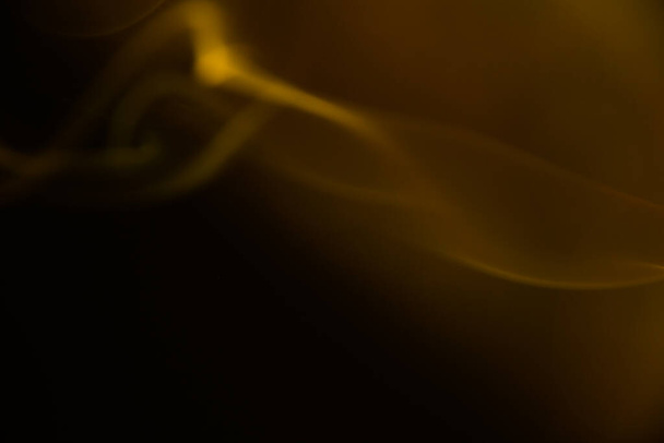 abstract orange-yellow background, glare and blur, surface ripples, radiance and sparks - Foto, Imagen