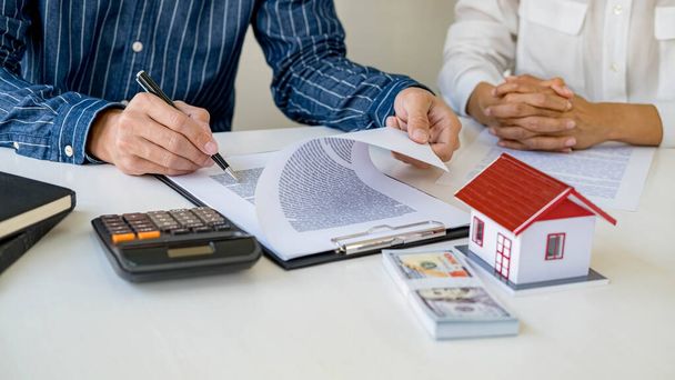 Real estate agent and customer signing contract to buy house, insurance or loan real estate. - Photo, Image