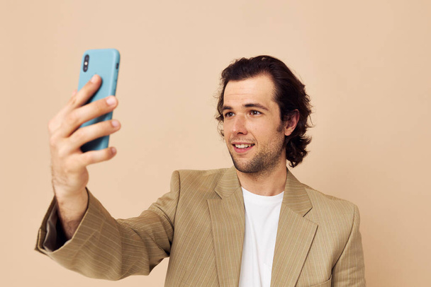 Cheerful man takes a selfie classic style technologies isolated background - Photo, Image