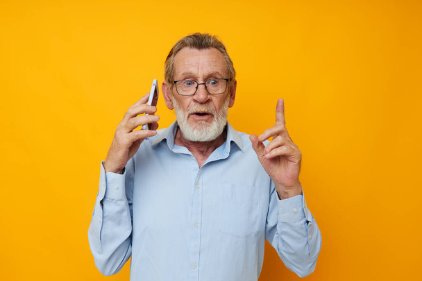 Portrait of happy senior man talking on the phone emotions isolated background - Photo, Image