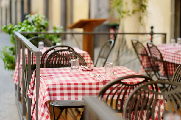 Outdoor restaurant table in Orvieto, a medieval hill town, rising above the almost-vertical faces of tuff cliffs and surrounded by its vineyards and wineries in Umbria, Italy. - Φωτογραφία, εικόνα