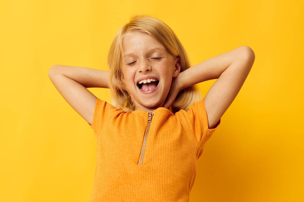 kid girl smile hand gestures posing casual wear fun color background unaltered - Fotó, kép